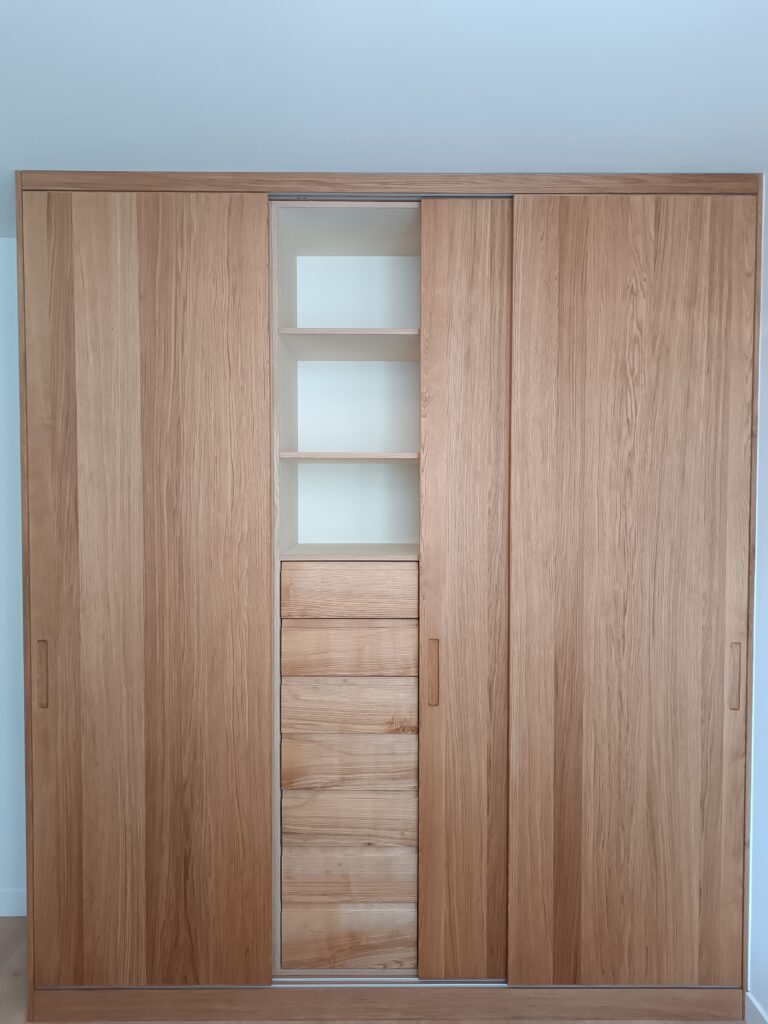 Custom-made oak veneer cabinet with sliding doors